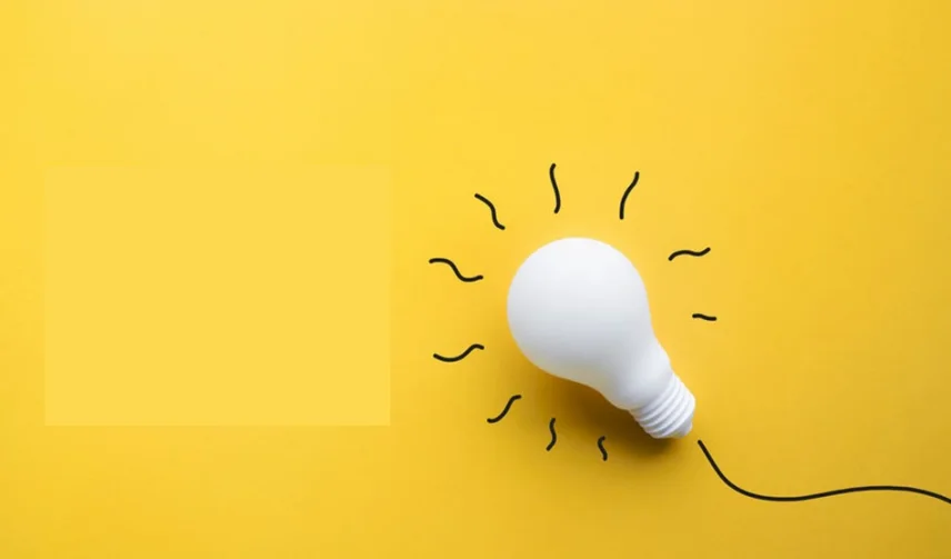 A white light bulb on a yellow background.