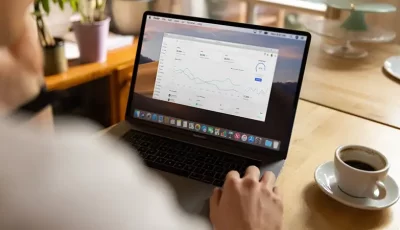 A man looking at at graphs on his laptop