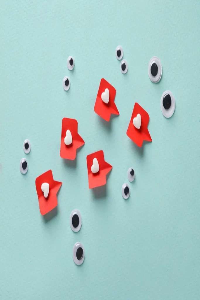 A group of fake eyes and paper hearts on blue background