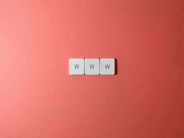 Three keyboard keys, each labeled with the letter W, are placed side by side on a solid coral-colored background